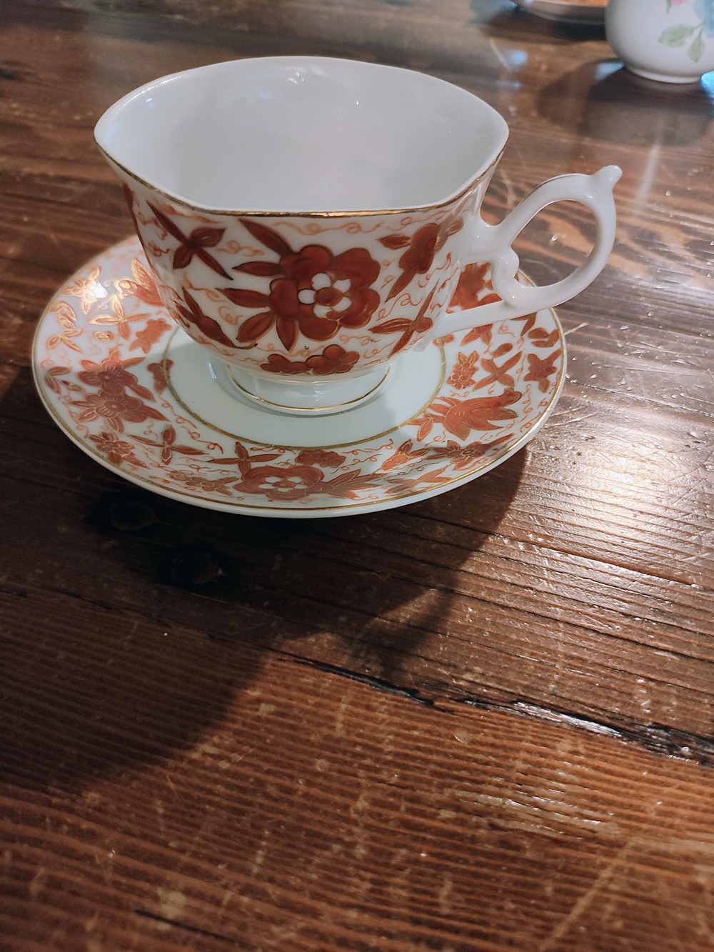 Porcelain Teacup and Saucer - White with Rust Floral Pattern